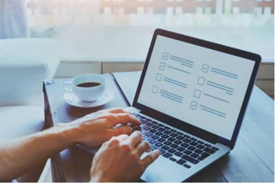 Person filling out a form on laptop